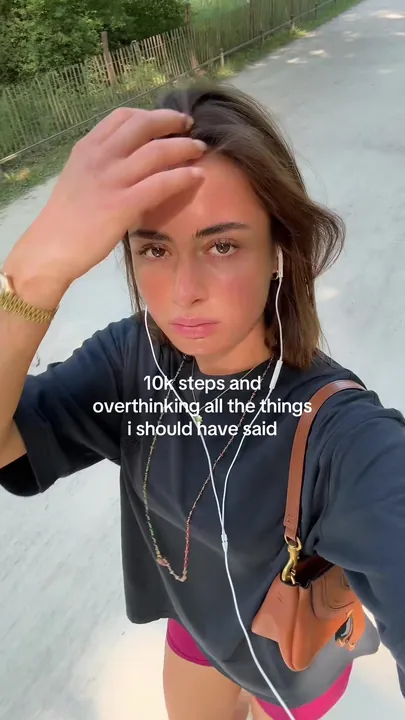 Vinaya walking with earphones in, hand on her forehead, caption about 10k steps